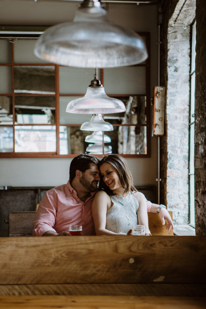man and woman snuggling in a restaurant booth