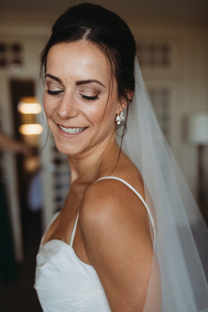 a bride looks down and smiles